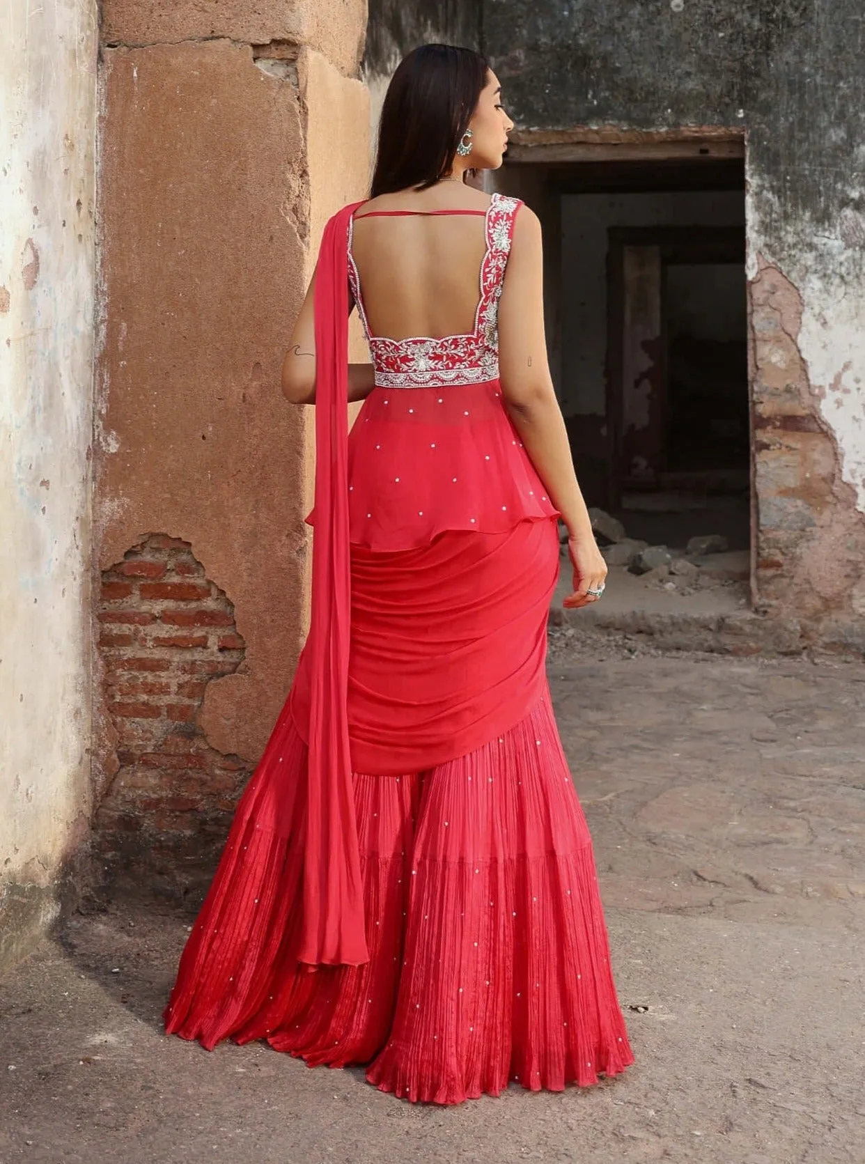 Nikhita coral pink draped sari and peplum