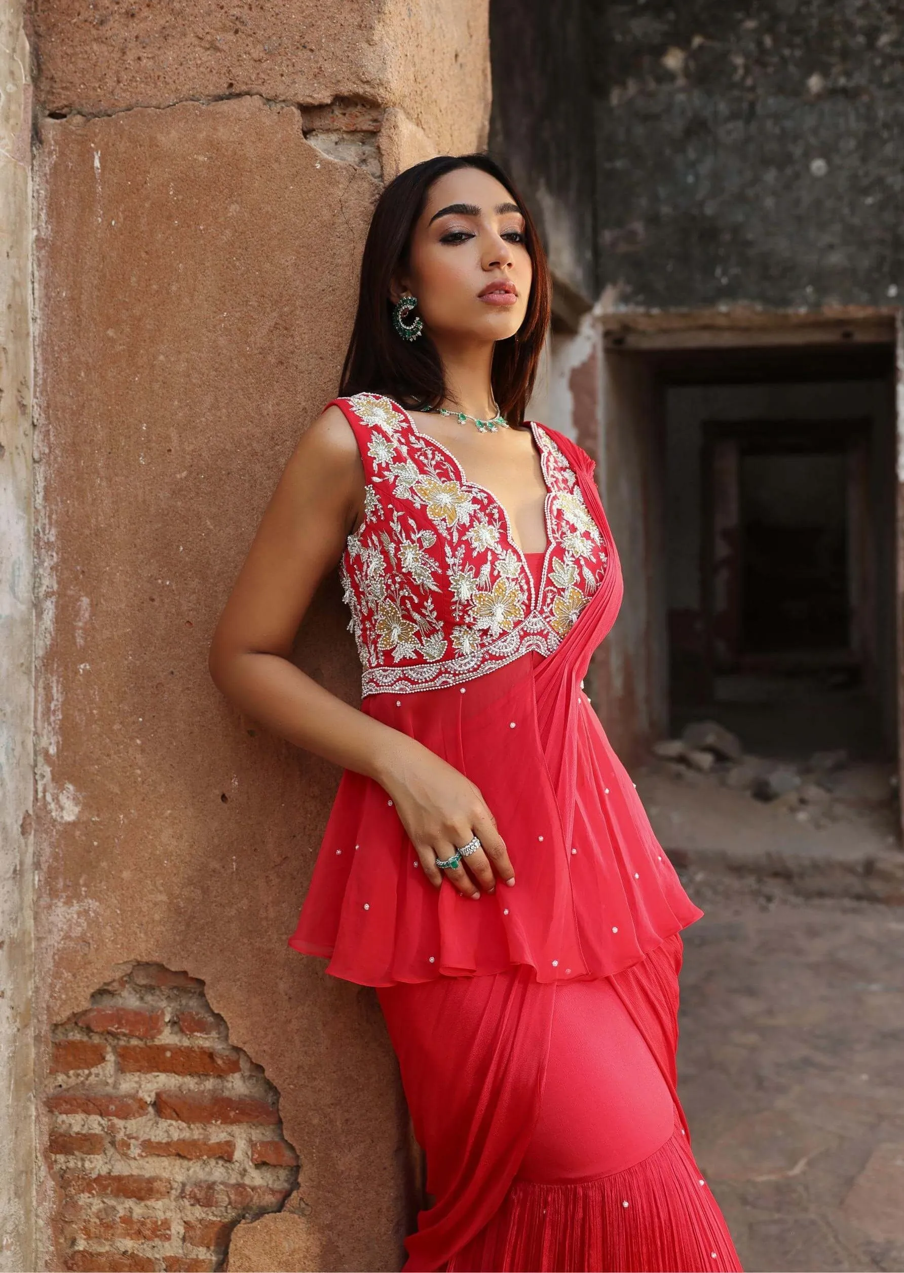 Nikhita coral pink draped sari and peplum