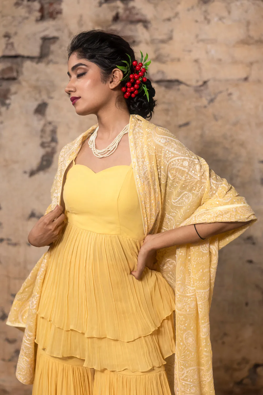 Yellow Pleated Sharara Paied With Peplum Top And Embroidered Dupatta